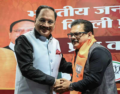 New delhi nov 29 ani delhi bjp state president virendra sachdeva shakes welcomes former aam aadmi party mla rajesh gupta as he joins the bjp in new delhi.jpg