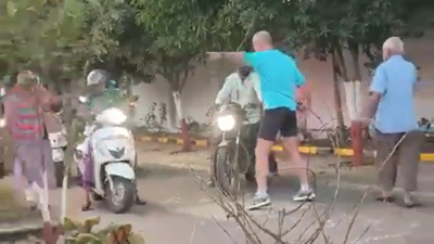 Foreigner stops bikers to ride on footpath in pune.jpg