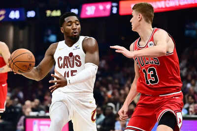 Cleveland cavaliers guard donovan mitchell 45 drives to the basket against chicago bulls guard kevin huerter 13.jpg