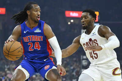Detroit pistons guard daniss jenkins 24 dribbles beside cleveland cavaliers guard donovan mitchell 45.jpg