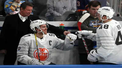 Nhl connor mcdavid 97 of the edmonton oilers celebrates on the bench if front of wayne gretzky during the 2020 nhl all star game.jpg