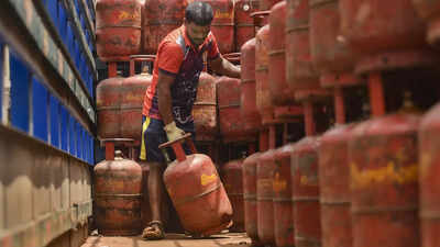 Mumbai a worker unloads domestic lpg gas cylinders from a truck in mumbai oil.jpg